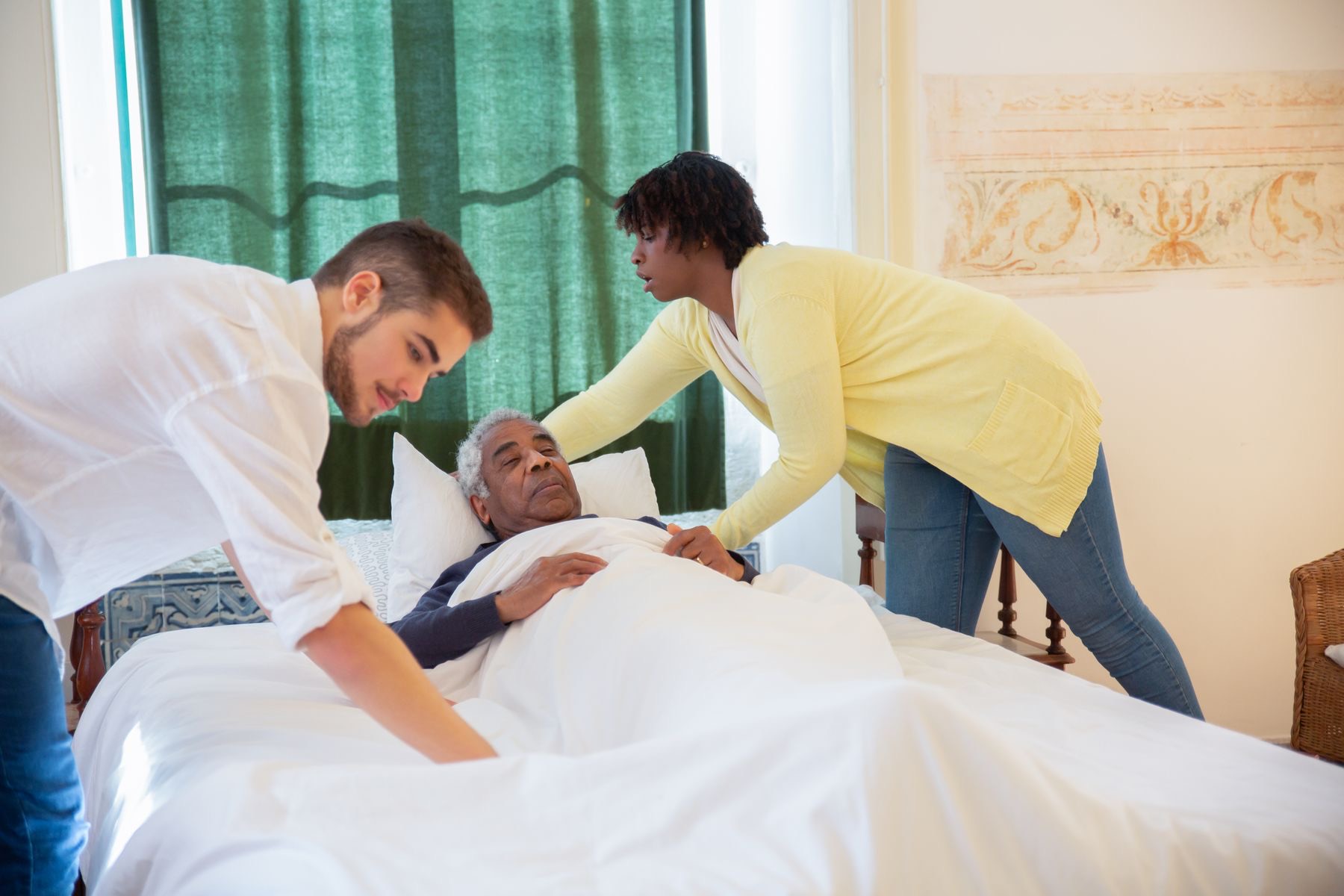A caregiver smiling warmly while caring for a patient at home